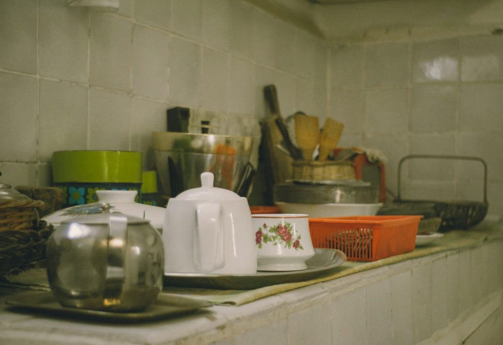 Various kitchenware items arranged on a shelf.