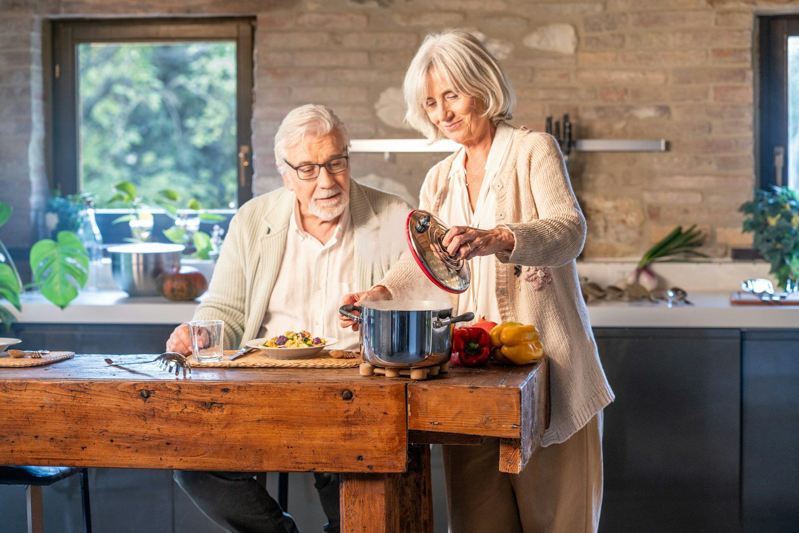 Elderly couple cooking together in a modern kitchen.