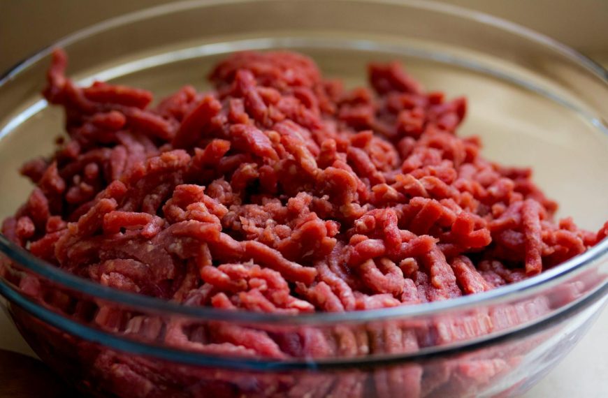 High-quality image of fresh ground beef in a glass bowl, ideal for culinary and food-related themes.