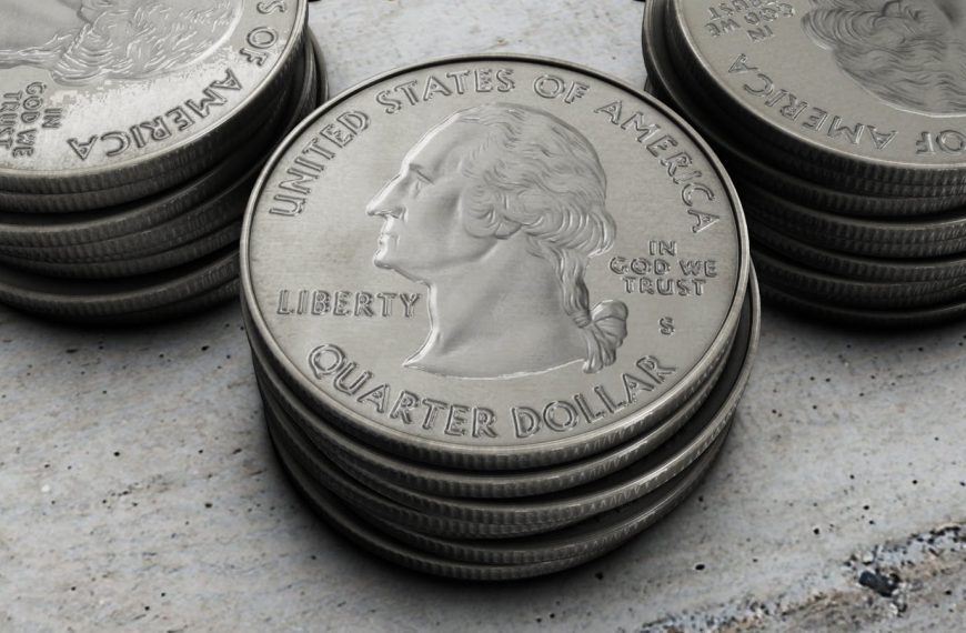 Detailed image of stacked silver US quarter coins showing engraved design.
