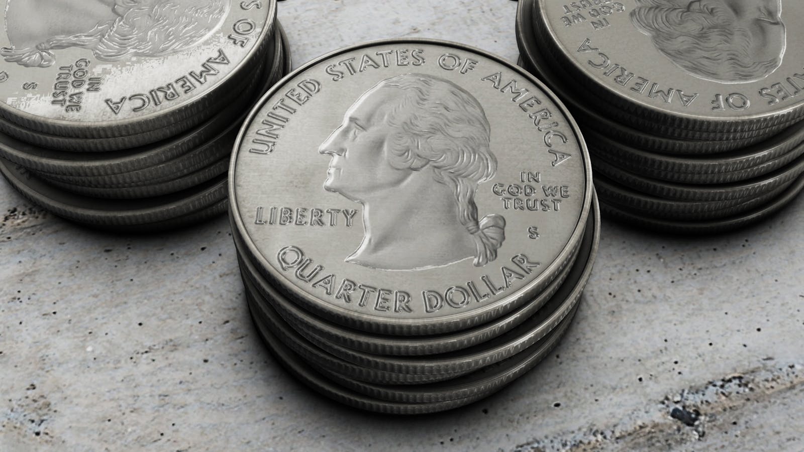 Detailed image of stacked silver US quarter coins showing engraved design.
