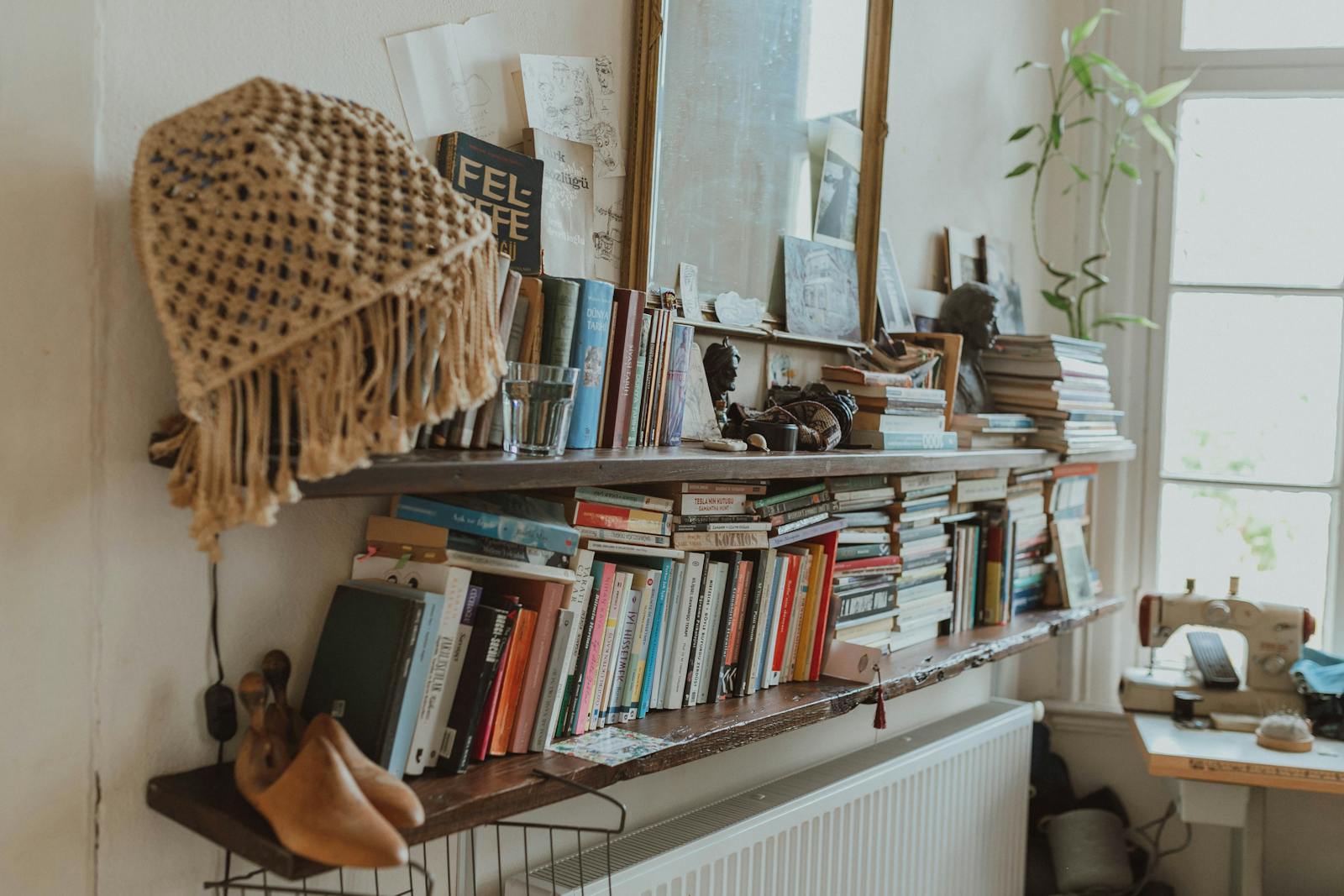 A cozy home library featuring a vintage bookshelf with assorted books and decor items.