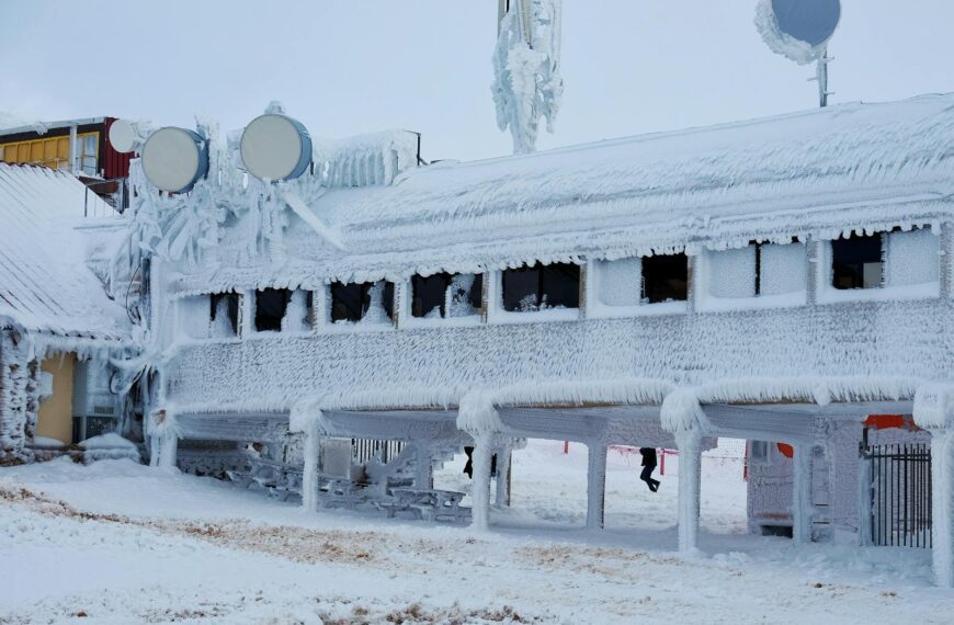 A frozen building covered in thick ice and snow, showcasing extreme winter conditions.