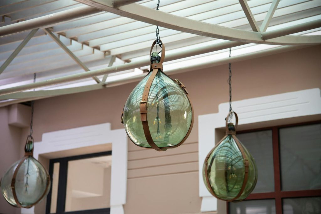 Decorative glass lamps with metal fixtures hanging from the ceiling, creating a classic aesthetic.
