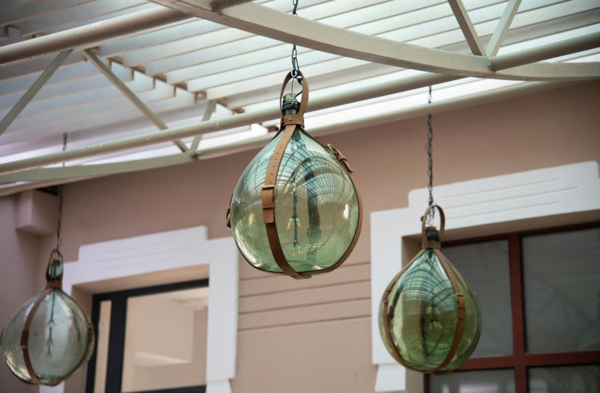 Decorative glass lamps with metal fixtures hanging from the ceiling, creating a classic aesthetic.