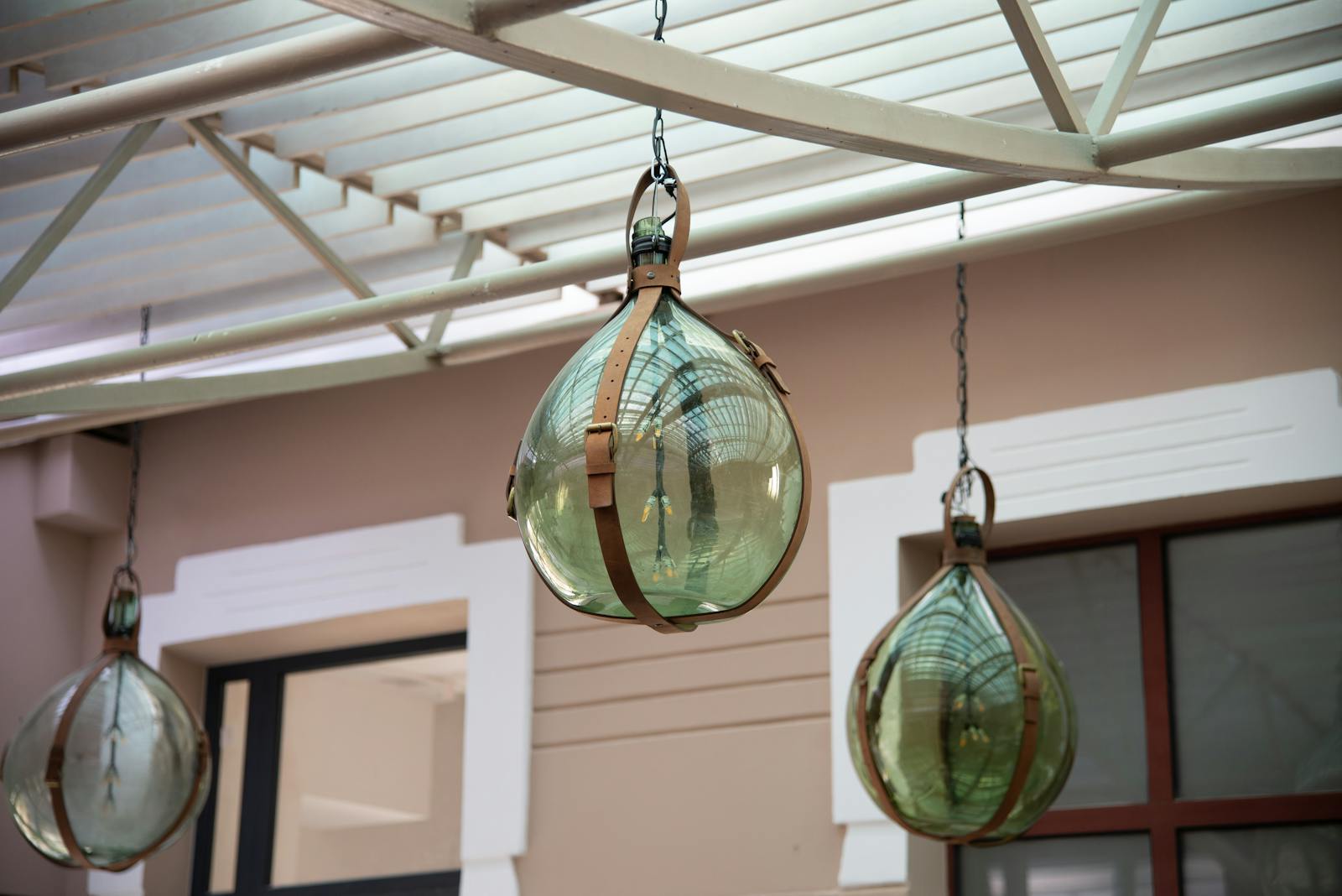 Decorative glass lamps with metal fixtures hanging from the ceiling, creating a classic aesthetic.
