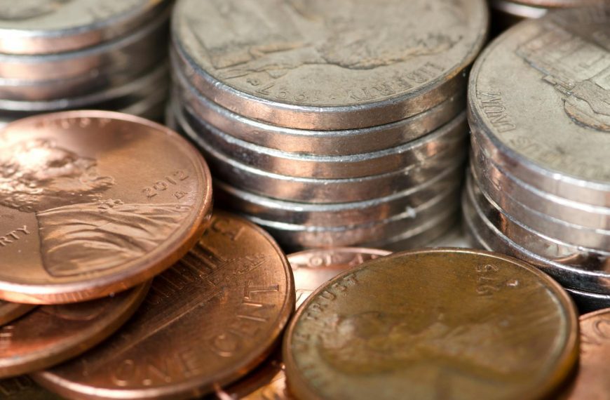 Detailed image of stacked American coins including pennies and nickels, representing savings and finance.