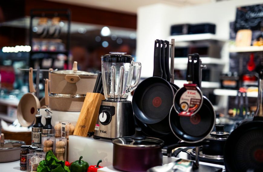 A vibrant selection of modern kitchen utensils including pans, blenders, and accessories.
