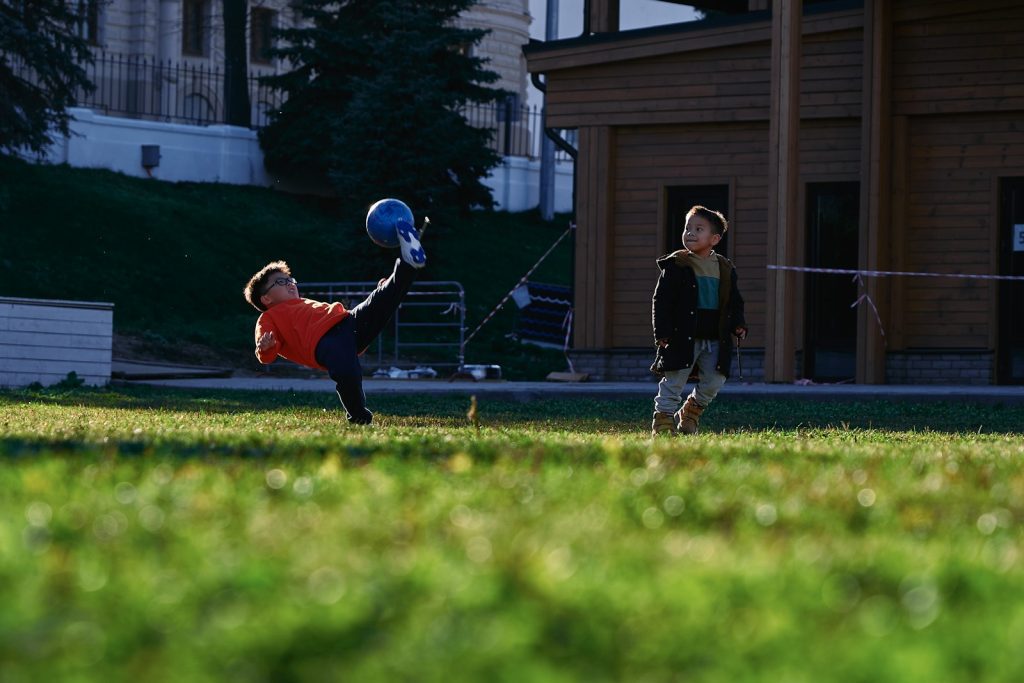 a small child swinging a bat at a ball
