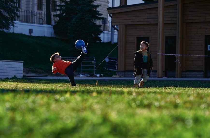 a small child swinging a bat at a ball