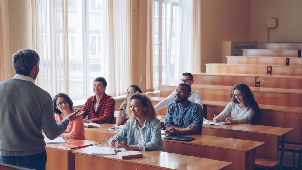 Professor teaching students in a lecture hall.