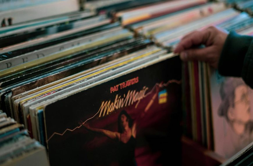 Person browsing vinyl records collection in a Cambridge store. Nostalgic and retro vibe.