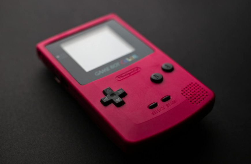 Red Nintendo Game Boy close-up showcasing retro gaming console design.