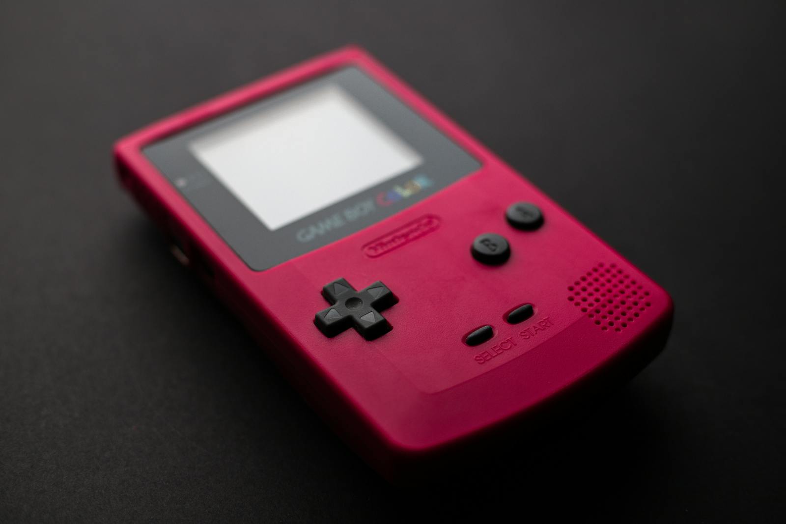Red Nintendo Game Boy close-up showcasing retro gaming console design.