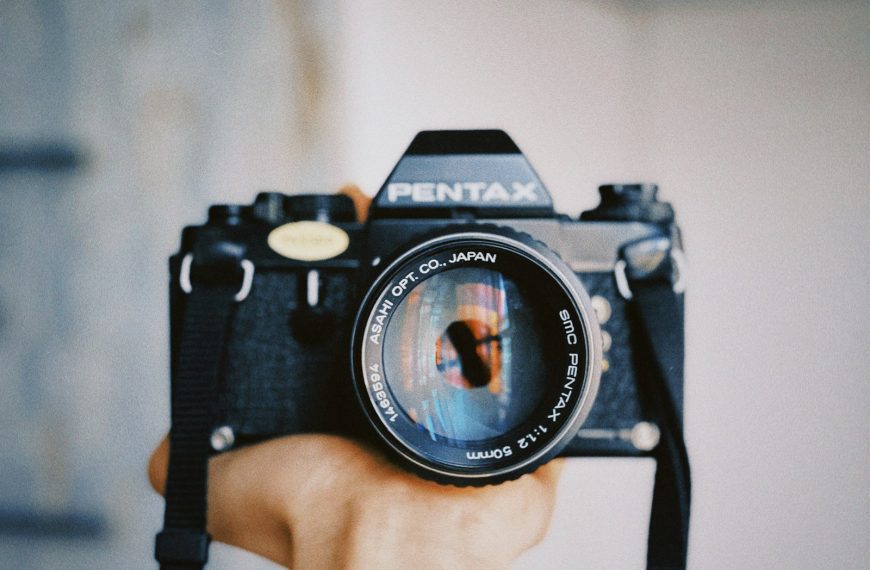 a person holding a camera up to take a picture