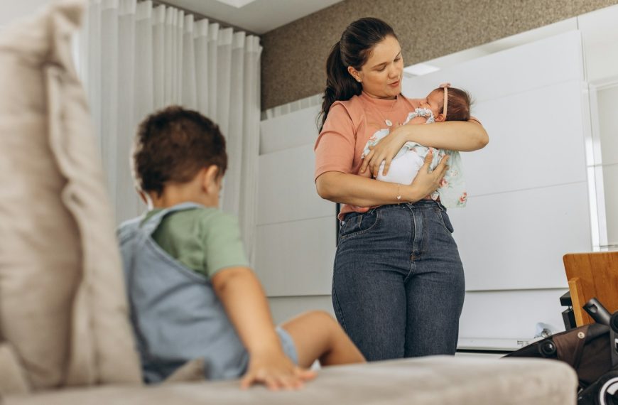 a woman holding a baby in her arms