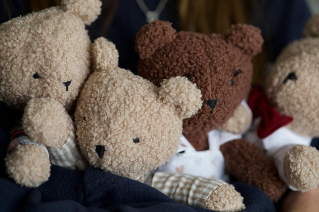 A heartwarming close-up of adorable plush teddy bears nestled together.