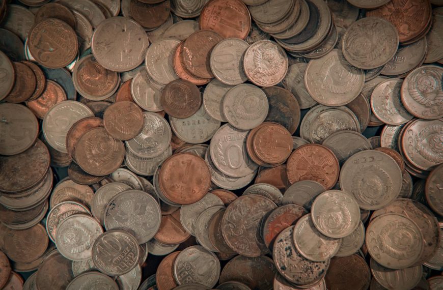 Close-up view of assorted foreign coins in a large mixed pile, perfect for finance-related projects.