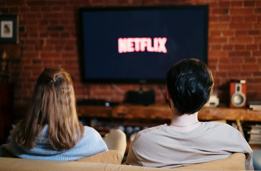 A couple enjoys a relaxed evening watching Netflix in their living room.