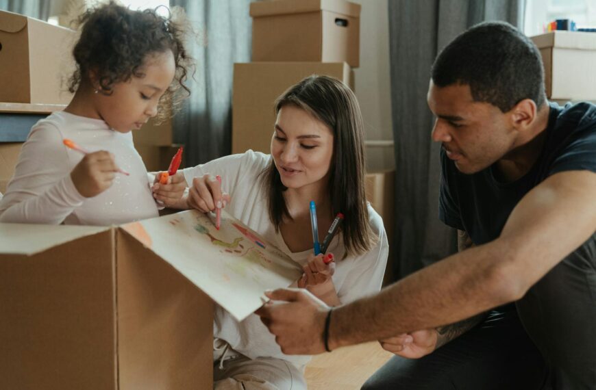 Family enjoying a creative moment while moving into a new home.