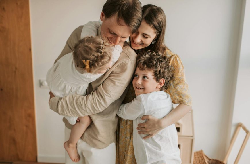 A heartwarming scene of a family hugging indoors, showcasing love and togetherness.
