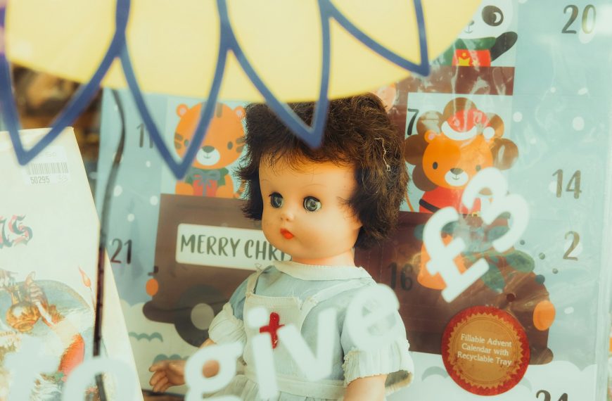 a doll with a red cross on it's shirt