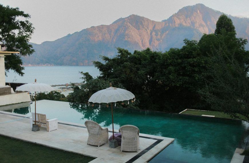 Relax by a serene infinity pool overlooking mountains and the ocean.