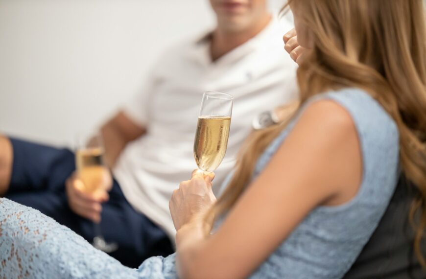 Couple enjoying champagne on a sofa