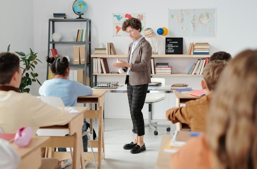 Teacher conducting a classroom lesson with attentive students in a vibrant educational setting.