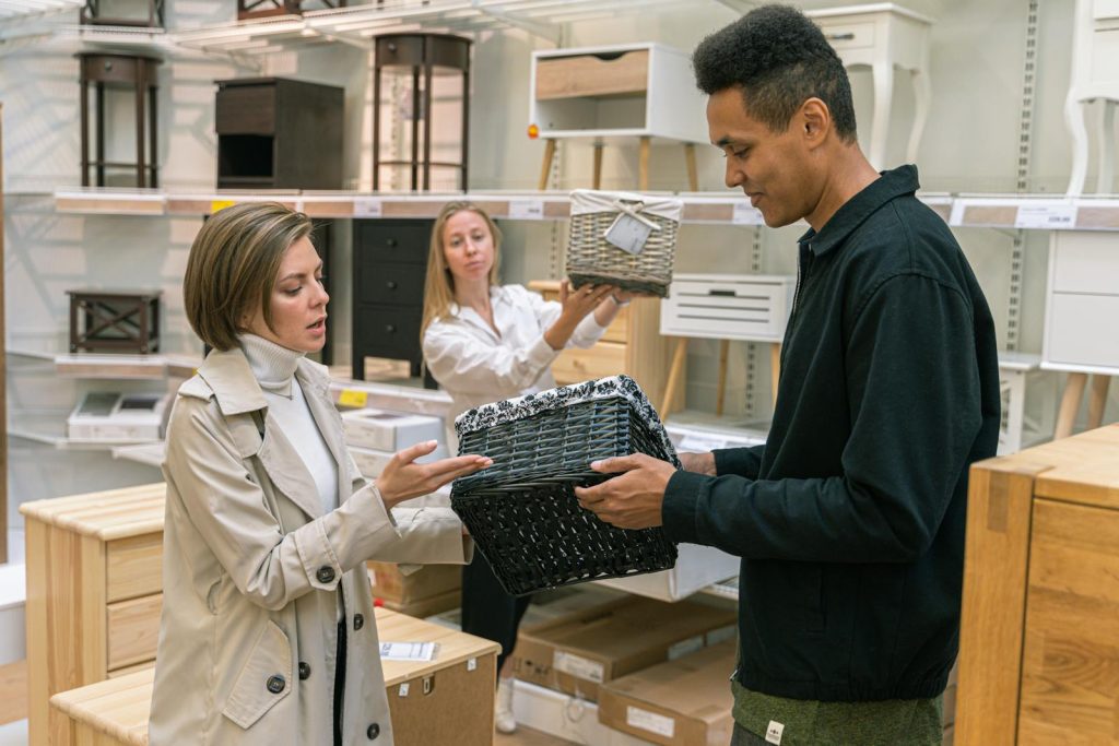 Customers and staff engaging with home goods products in a retail environment.