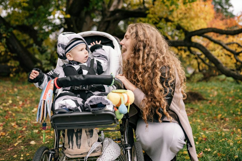 A joyful moment of a mother and child spending time together in a fall park.
