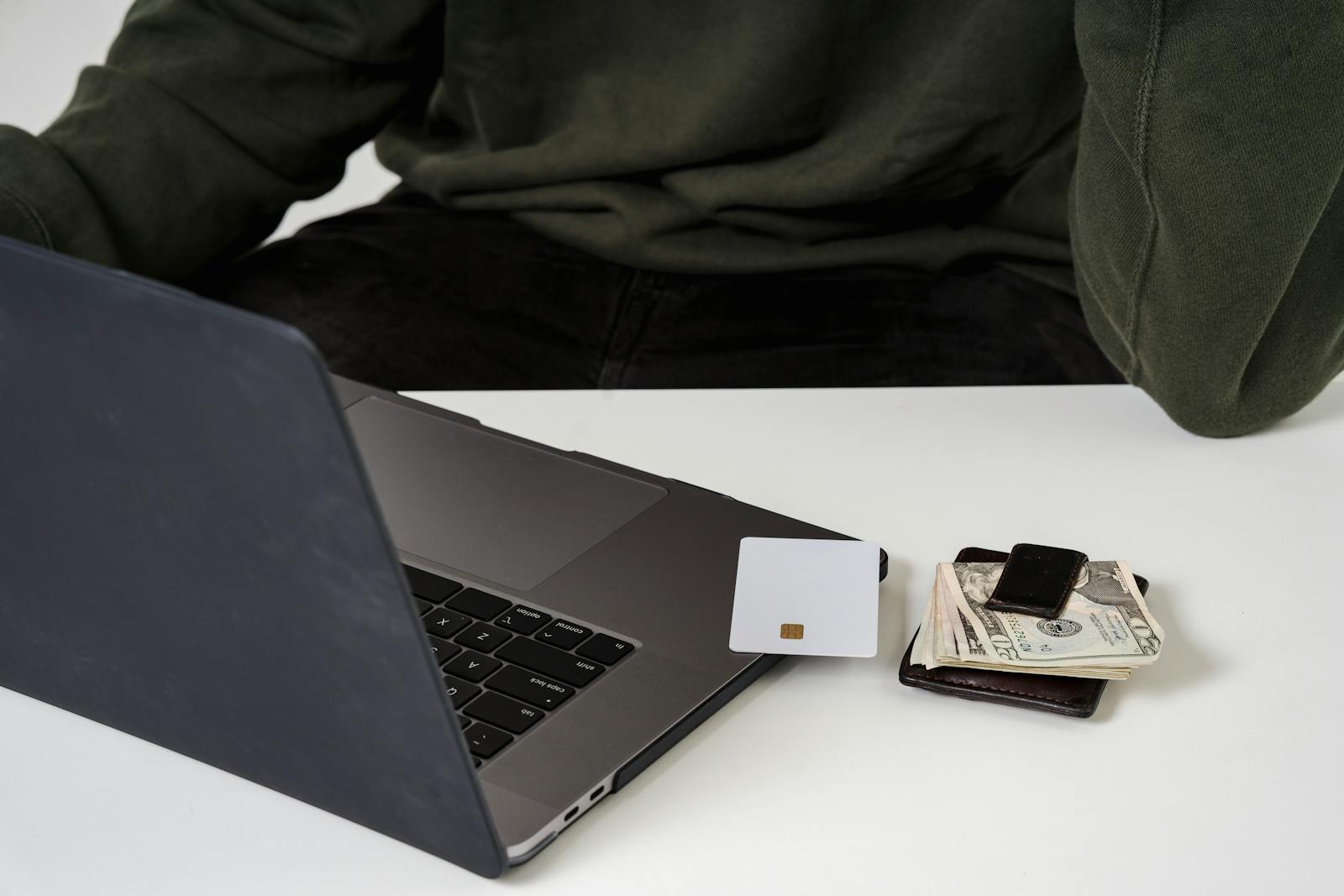 A man using a laptop and credit card for online shopping, highlighting e-commerce convenience.
