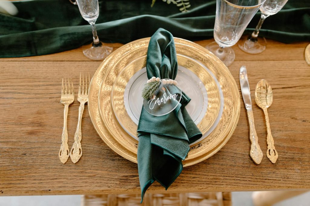 Sophisticated green and gold table setting ideal for festive events.