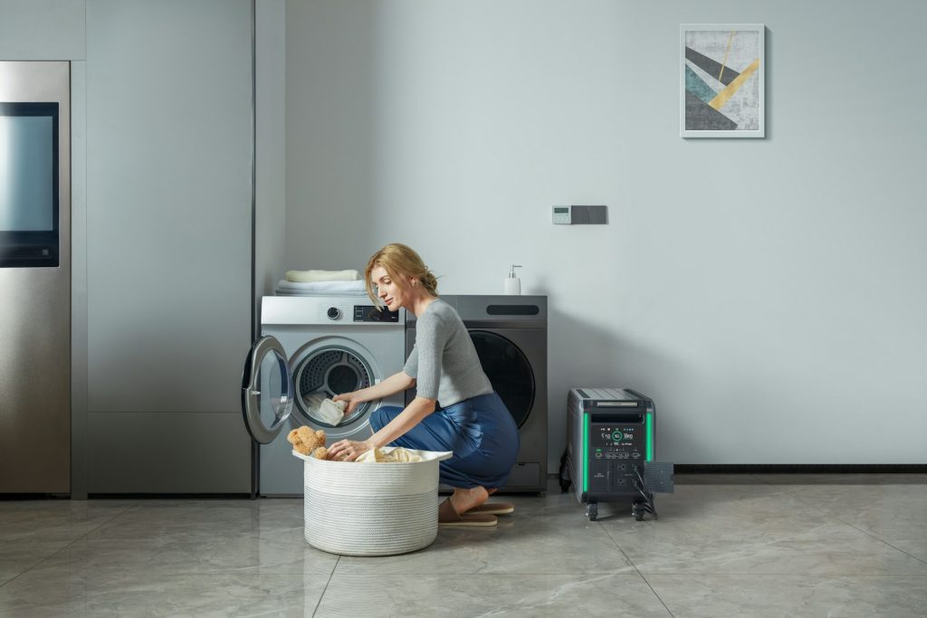 a woman loading a washing machine into a laundry basket