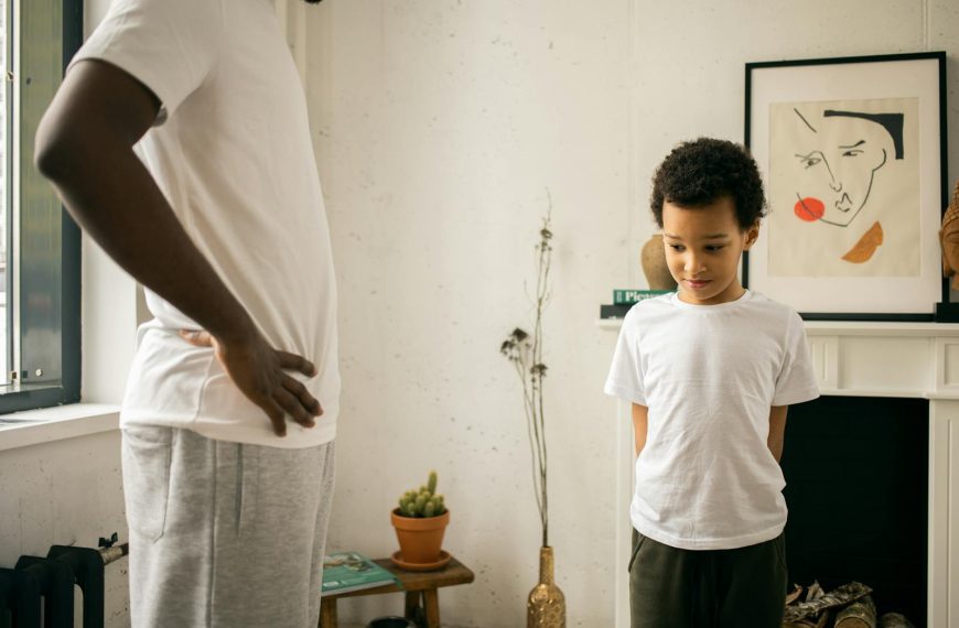 A father and son share a serious moment indoors, representing parenthood and family dynamics.