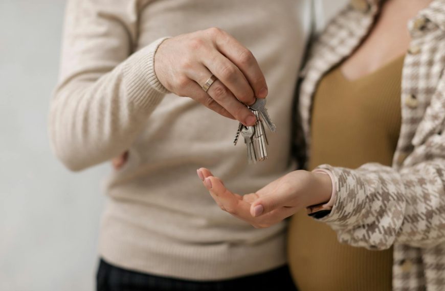 Happy couple receiving keys to their new home, symbolizing a new beginning.