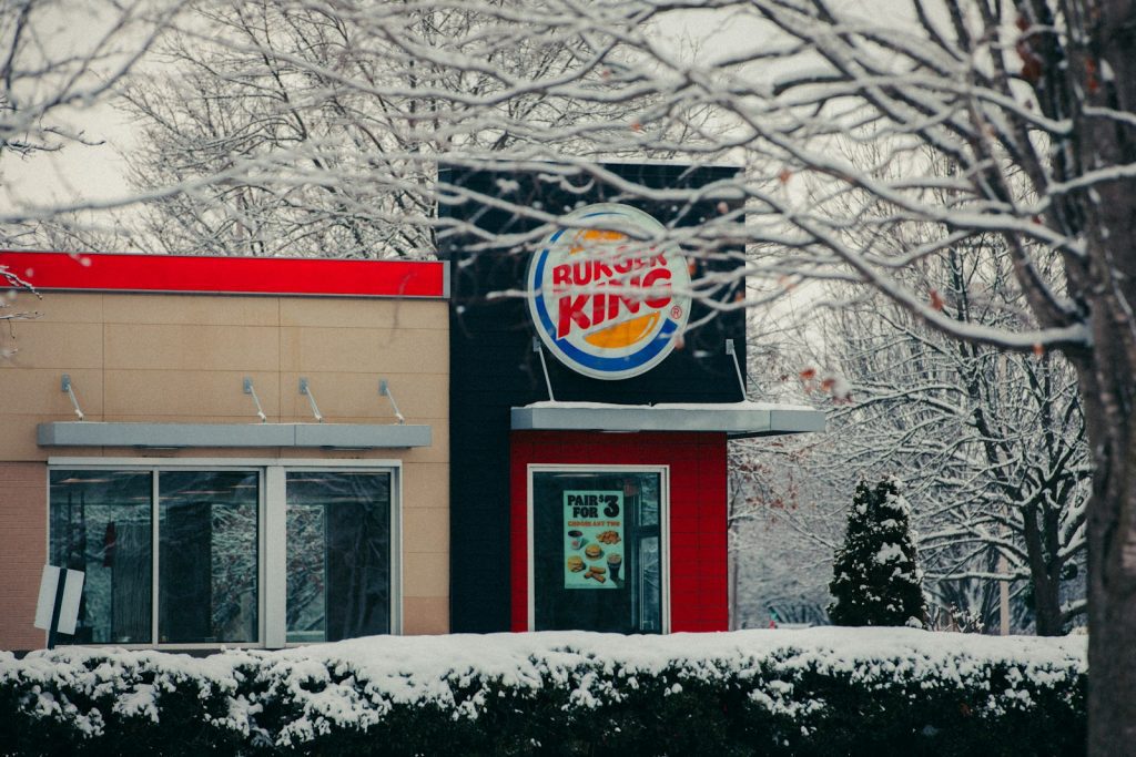 Burger king restaurant covered in snow.