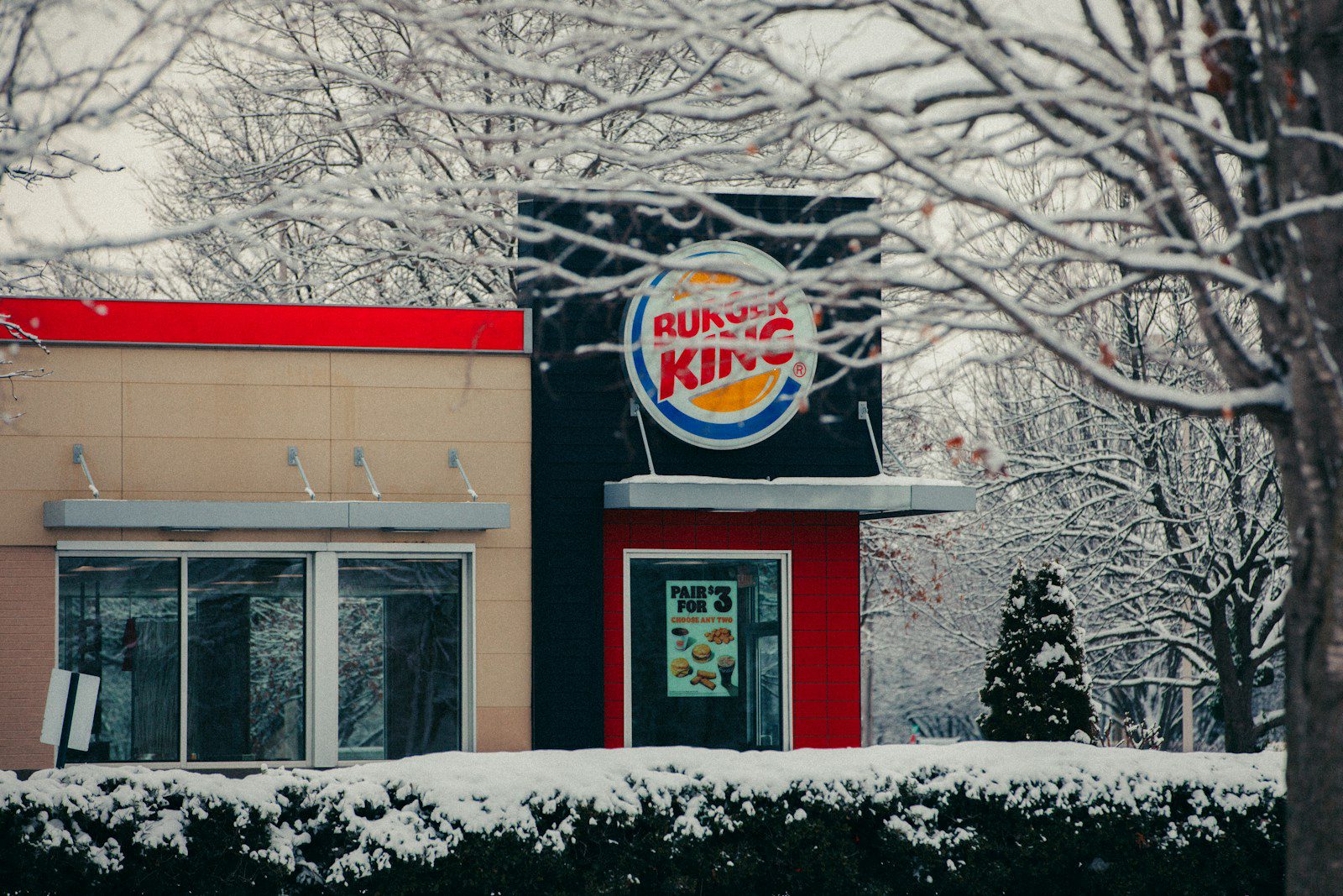 Burger king restaurant covered in snow.