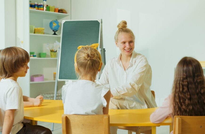 Teacher engaging with preschool children in a colorful classroom setting.