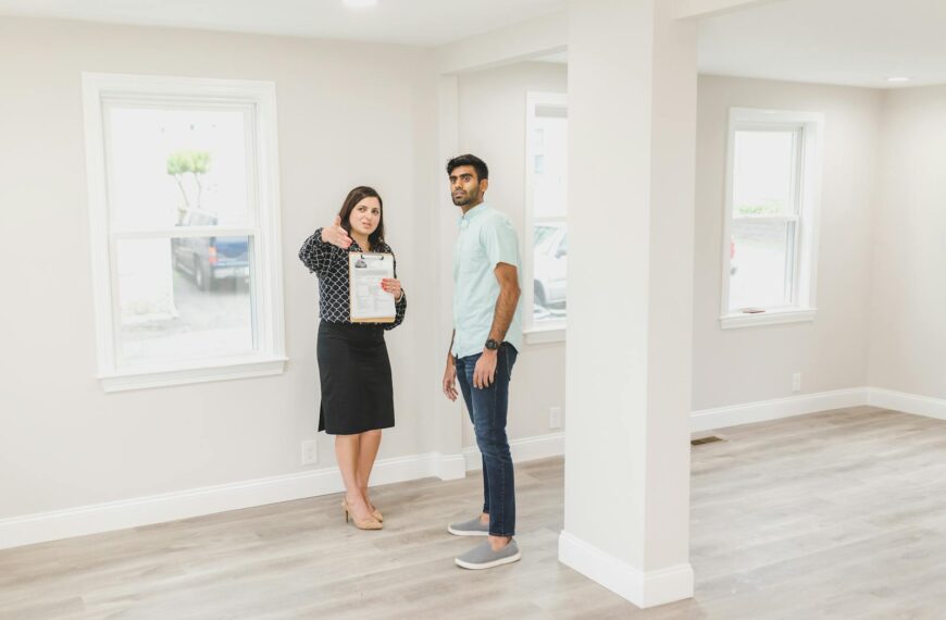 A real estate agent showing a potential buyer the interior of a new home.