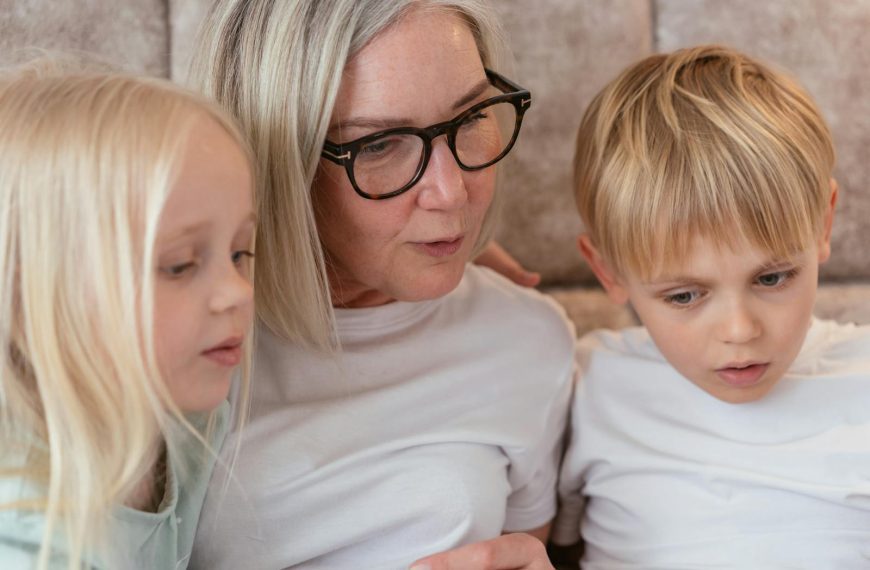 A grandmother and her grandchildren enjoy quality time together indoors.