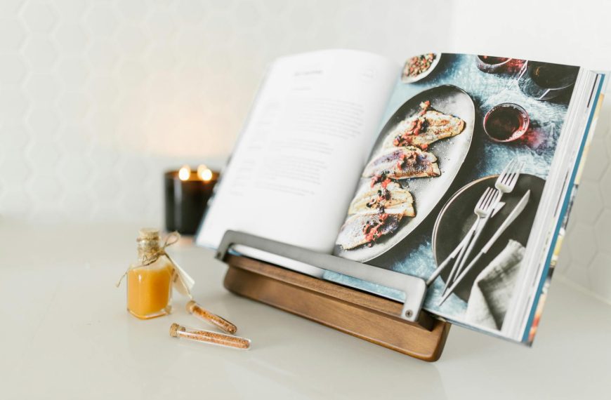 Open cookbook with a delicious fish recipe, styled with candlelight ambience.
