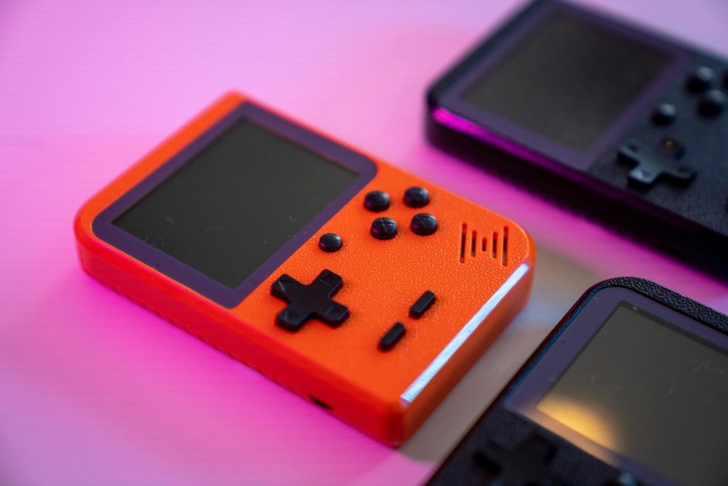Vibrant and nostalgic handheld gaming console in focus, showcasing retro design with a pop of color.