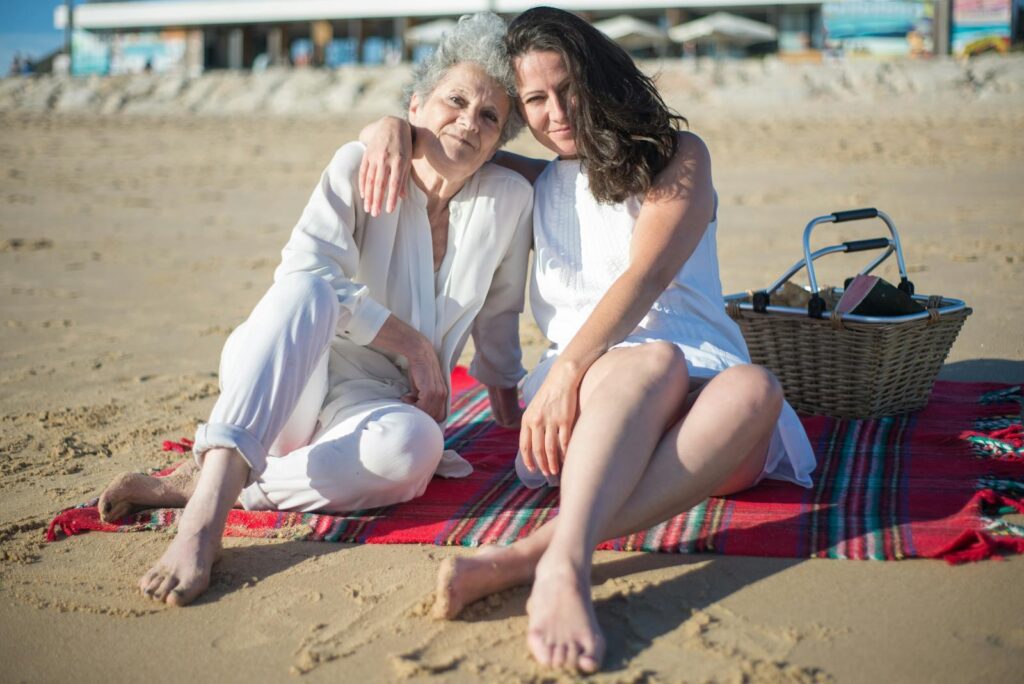 A touching scene of a mother and daughter enjoying a sunny beach day in Portugal.