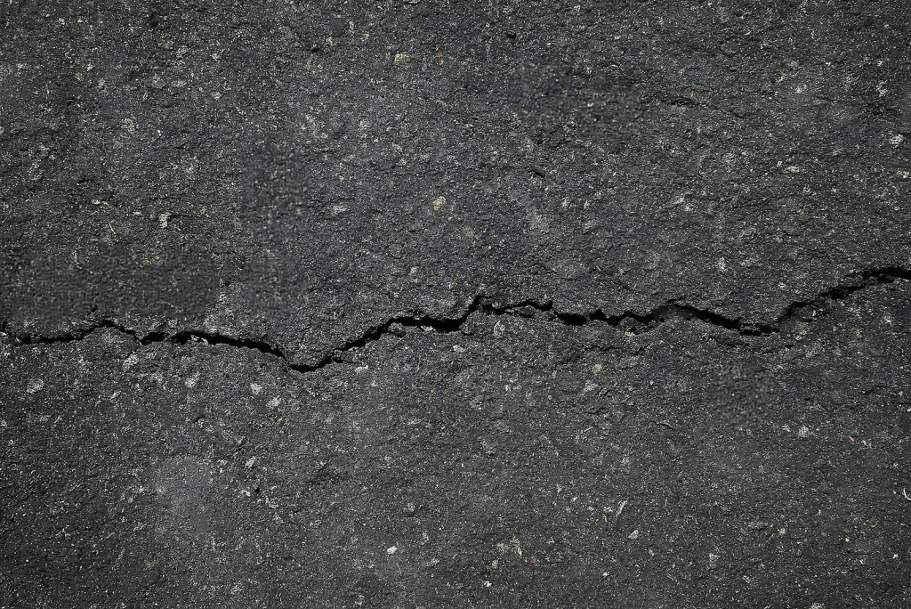 A crack in the asphalt of a street