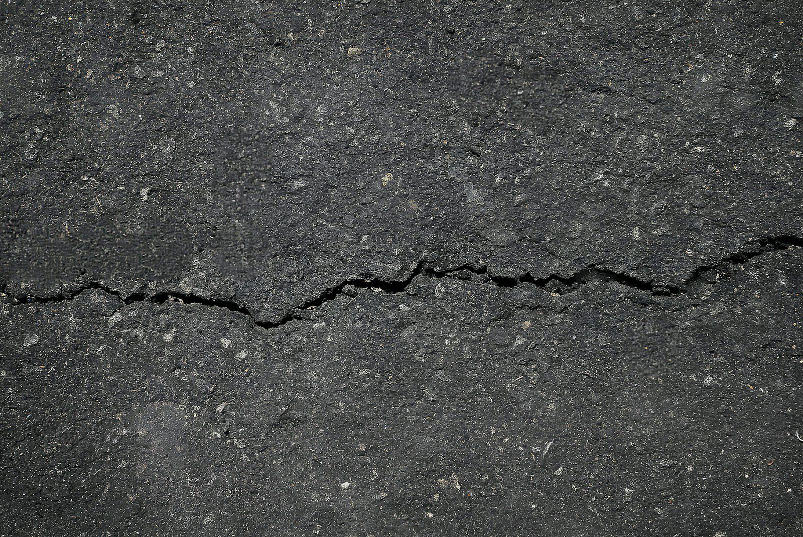 A crack in the asphalt of a street