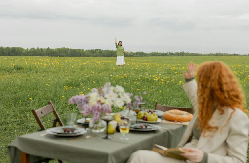 A relaxing spring picnic with friends in a vibrant dandelion field. Enjoy a peaceful outdoor dining experience.