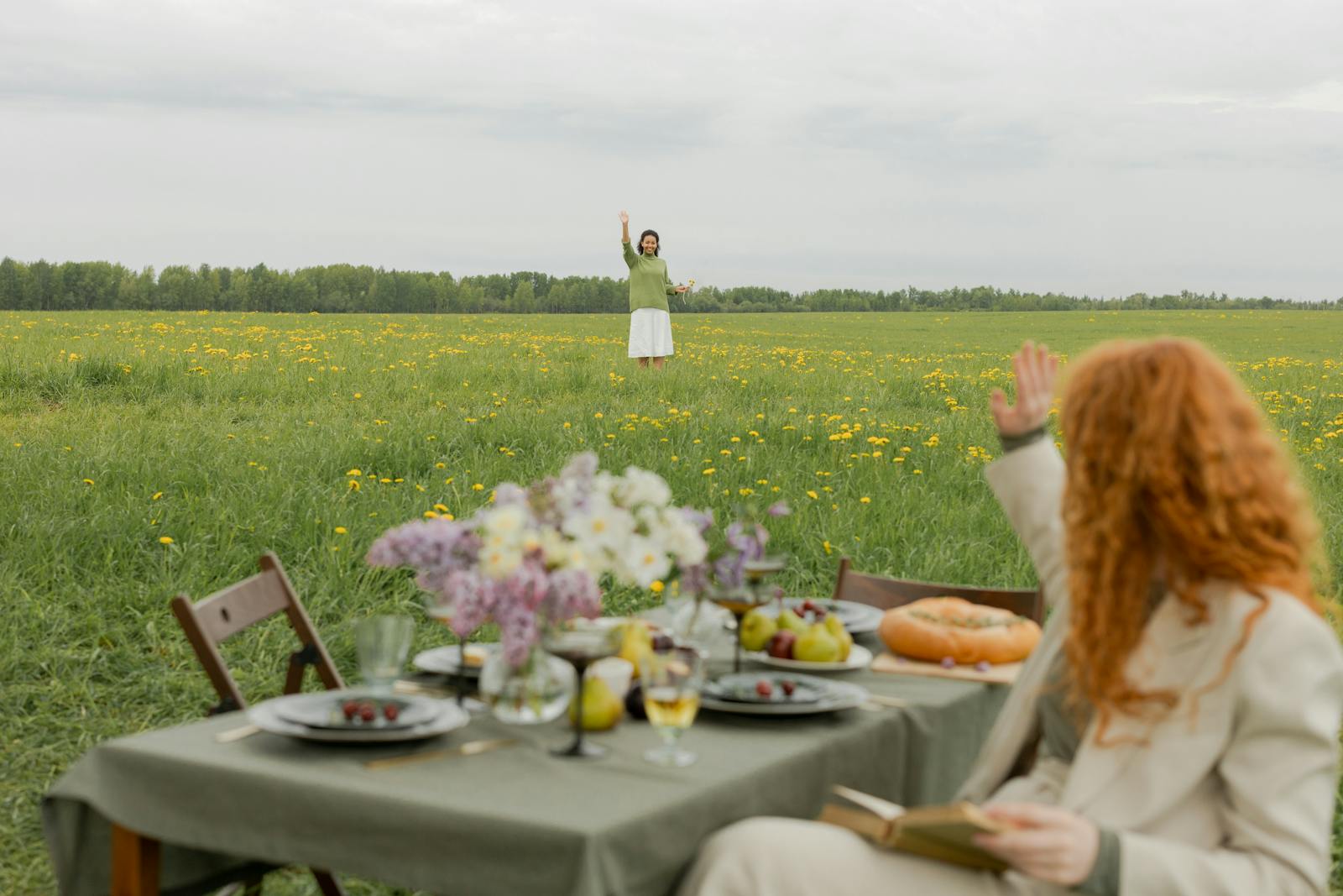 A relaxing spring picnic with friends in a vibrant dandelion field. Enjoy a peaceful outdoor dining experience.
