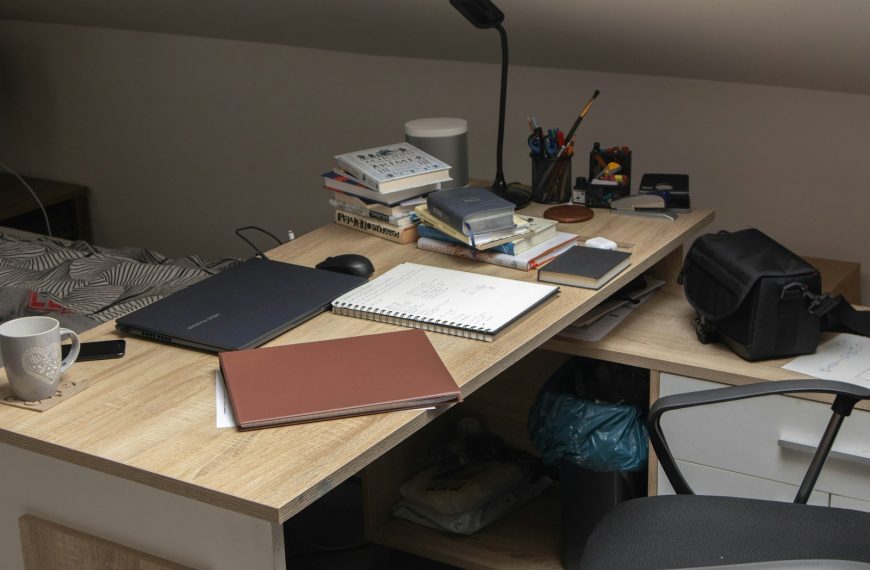 a wooden desk topped with a laptop computer