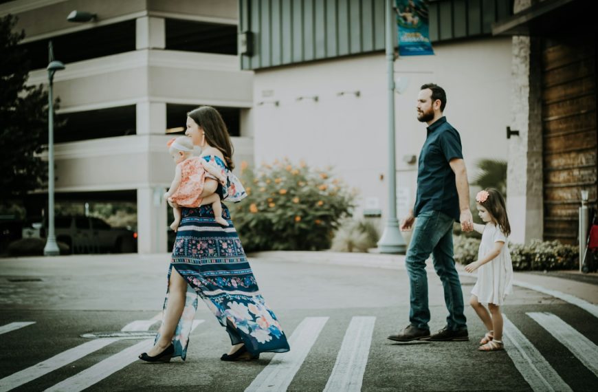 man and woman crossing road